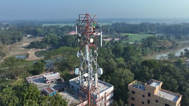 Aerial view of a telecommunications tower with a technician Bangladesh.