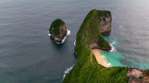 Aerial view of Kelingking Beach with its iconic T Rex shaped cliff Indonesia. Aerial view of Kelingking Beach with its iconic T Rex shaped cliff Indonesia.
