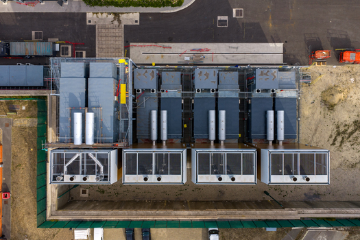 Aerial view of the Ark Data Centres facility at Longcross Park featuring modular units and industrial equipment on the roof in Chertsey England United Kingdom. Aerial view of the Ark Data Centres facility at Longcross Park featuring modular units and industrial equipment on the roof in Chertsey England United Kingdom.