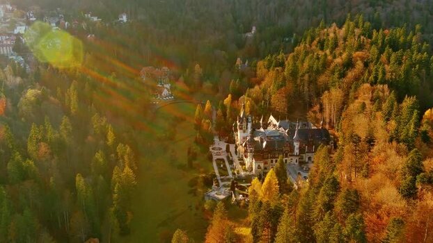Aerial view of Peles Castle in autumn forest Romania. Aerial view of Peles Castle in autumn forest Romania.