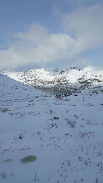 Aerial view of snow covered mountains on Kvaloya island Norway.