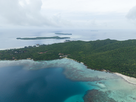 Aerial view of turquoise waters meeting the verdant coastline a symphony of blues and greens under a vast sky Karimunjawa Central Java Indonesia.