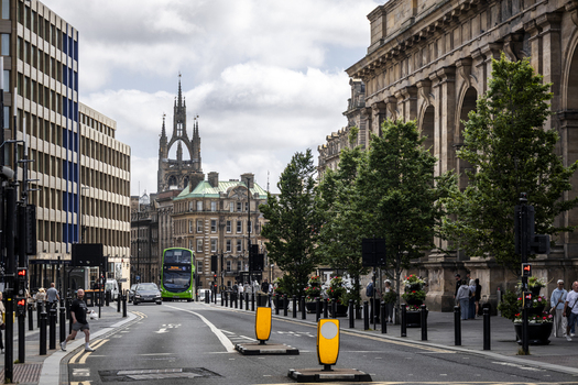 Newcastle upon Tyne England United Kingdom 13 July 2026 View of a busy street with the historic St Nicholas Cathedral in the background a green bus and pedestrians. Newcastle upon Tyne England United Kingdom 13 July 2026 View of a busy street with the historic St Nicholas Cathedral in the background a green bus and pedestrians.