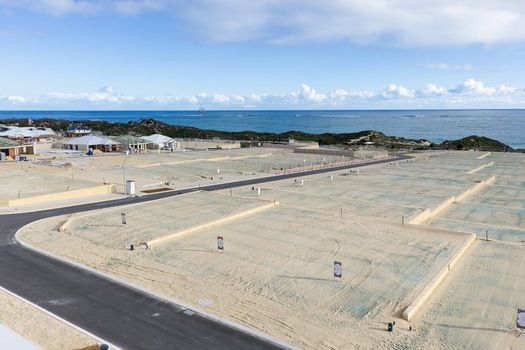 Aerial view of a residential development site with cleared sandy plots paved roads and construction markers overlooking the Indian Ocean in Perth Western Australia Australia. Aerial view of a residential development site with cleared sandy plots paved roads and construction markers overlooking the Indian Ocean in Perth Western Australia Australia.