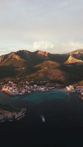 Aerial view of Sant Elm coastal village and mountains Spain.