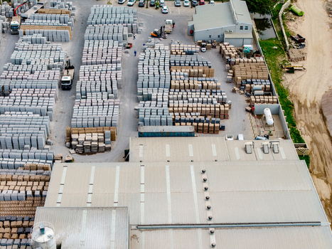 Aerial view of the industrial facility in Philippi with rows of stacked paving stones warehouse buildings and transport vehicles in Cape Town Western Cape South Africa.