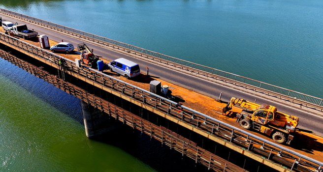 Aerial view of Smederevo bridge and shipyard with construction vehicles and traffic on the road surface in Smederevo Podunavlje District Serbia.