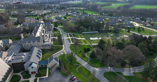 Aerial view of the retirement community campus featuring stone buildings manicured gardens and surrounding residential areas in West Donegal Township Pennsylvania United States.