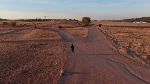 Aerial view of a person walking on a path in Caceres Spain.