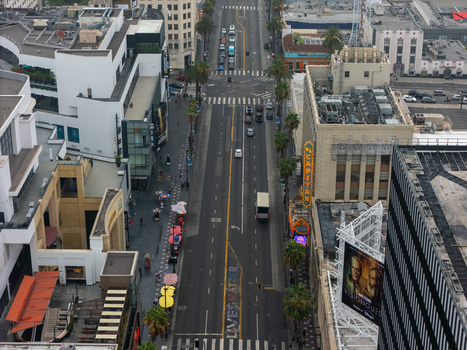 Los Angeles California United States 25 September 2026 Aerial view of the Hollywood Walk of Fame with palm trees historic buildings and traffic on the street.