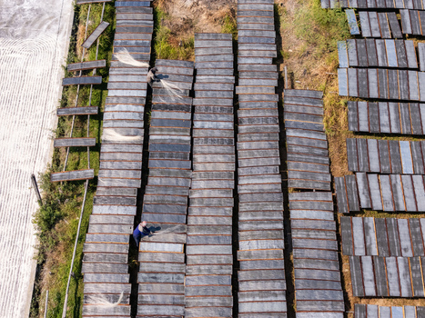 Aerial view of workers spreading sohun glass noodles on drying racks at the UKM Sohun production facility in Kecamatan Tulung Jawa Tengah Indonesia.