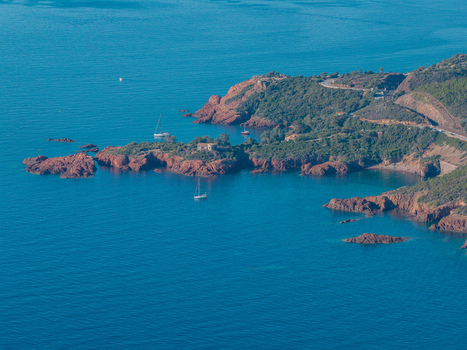 Aerial view of Le Trayas with its characteristic red rock cliffs coastal road and sailboats on the Mediterranean Sea in Saint Raphael Provence Alpes Cote d Azur France. Aerial view of Le Trayas with its characteristic red rock cliffs coastal road and sailboats on the Mediterranean Sea in Saint Raphael Provence Alpes Cote d Azur France.