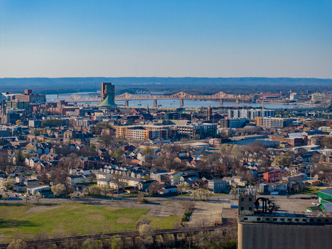 Aerial view of the urban landscape and bridges crossing the Ohio River under a clear blue sky in Louisville Kentucky United States. Aerial view of the urban landscape and bridges crossing the Ohio River under a clear blue sky in Louisville Kentucky United States.
