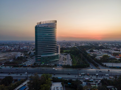 Aerial view of Arfa Kareem Tower with its modern glass facade during sunset overlooking the urban skyline and busy roads in Lahore Punjab Pakistan. Aerial view of Arfa Kareem Tower with its modern glass facade during sunset overlooking the urban skyline and busy roads in Lahore Punjab Pakistan.