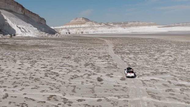 Aerial view of an off road vehicle driving through Tuzbair Kazakhstan.