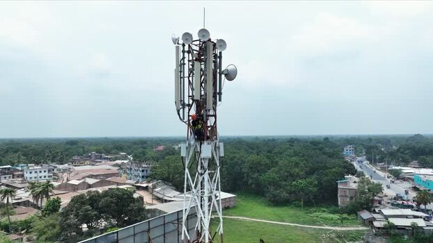 Aerial view of a technician working on a cell tower Bangladesh.