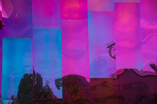 View of the iridescent and reflective metal facade of the Museum of Pop Culture with abstract distortions in Seattle Washington United States.