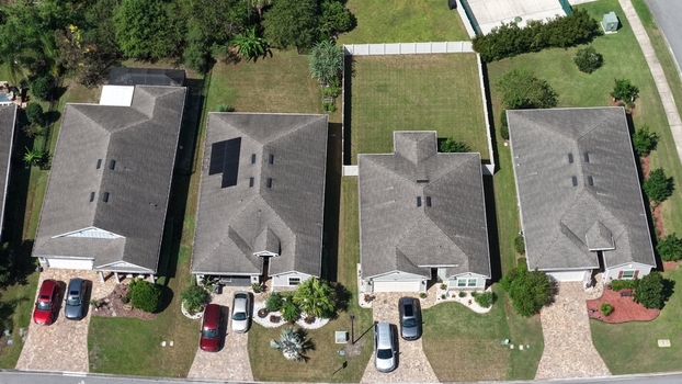 Aerial view of residential houses with driveways and parked cars along Windward Ranch Boulevard in St. Johns County Florida United States. Aerial view of residential houses with driveways and parked cars along Windward Ranch Boulevard in St. Johns County Florida United States.