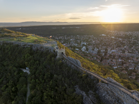 Aerial view of Ovech Fortress perched on a rocky plateau overlooking the town of Provadia at sunset with golden light illuminating the historic stone walls in Provadia Varna Bulgaria. Aerial view of Ovech Fortress perched on a rocky plateau overlooking the town of Provadia at sunset with golden light illuminating the historic stone walls in Provadia Varna Bulgaria.