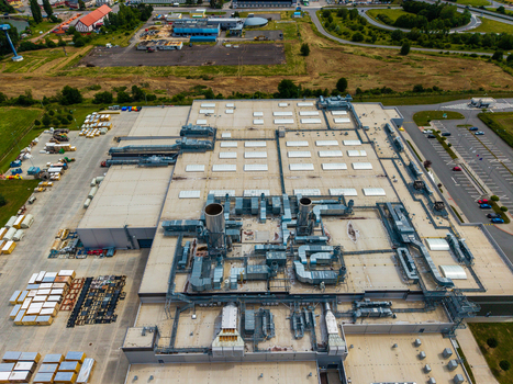 Aerial view of a large industrial facility with complex rooftop ventilation systems HVAC units and surrounding parking areas in Zebrak Central Bohemian Region Czechia. Aerial view of a large industrial facility with complex rooftop ventilation systems HVAC units and surrounding parking areas in Zebrak Central Bohemian Region Czechia.