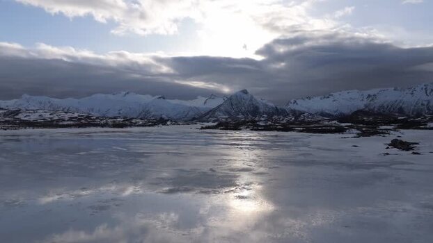 Aerial view of Lofoten mountains over frozen landscape Norway.