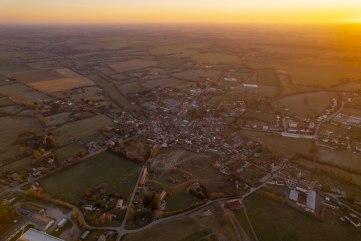 Aerial view of the village of Sap en Auge surrounded by rolling fields and farmland in the Normandy region of France at sunset Sap en Auge Normandy France. Aerial view of the village of Sap en Auge surrounded by rolling fields and farmland in the Normandy region of France at sunset Sap en Auge Normandy France.