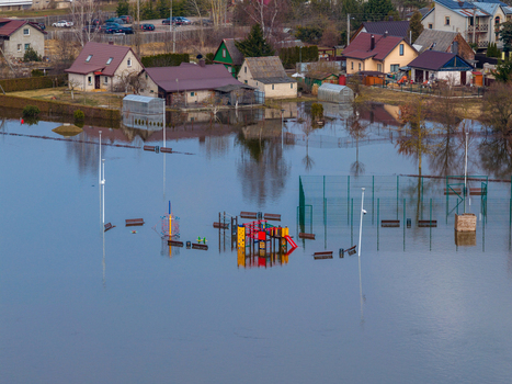 Kedainiai Lithuania 17 March 2026 Aerial view of a flooded residential area with a submerged playground and houses reflected in the still water during a spring flood. Kedainiai Lithuania 17 March 2026 Aerial view of a flooded residential area with a submerged playground and houses reflected in the still water during a spring flood.