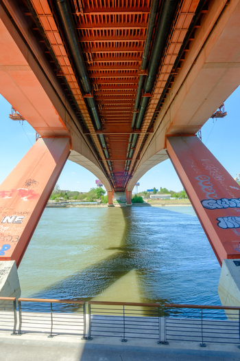 View of the underside of the Gazela Bridge with its orange steel structure and massive concrete pillars over the Sava River in Belgrade City of Belgrade Serbia.