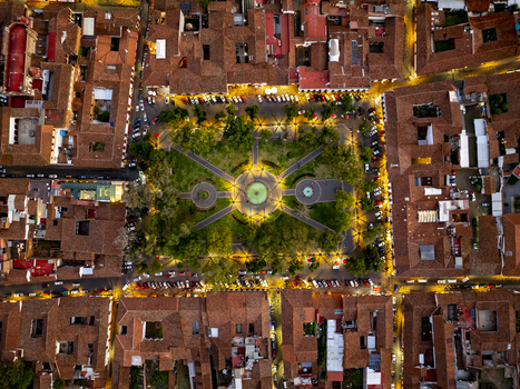 Aerial view of the illuminated Plaza Vasco de Quiroga surrounded by historic colonial buildings with terracotta rooftops in Patzcuaro Michoacan Mexico. Aerial view of the illuminated Plaza Vasco de Quiroga surrounded by historic colonial buildings with terracotta rooftops in Patzcuaro Michoacan Mexico.