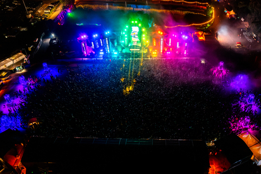 Herzogenaurach Germany 27 July 2025 Aerial view of Open Beatz Festival with a vibrant main stage illuminated by colorful neon lights and a large crowd of people at night. Herzogenaurach Germany 27 July 2025 Aerial view of Open Beatz Festival with a vibrant main stage illuminated by colorful neon lights and a large crowd of people at night.
