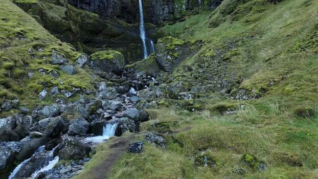 Aerial view of Bugsfoss waterfall in the green hills Iceland.