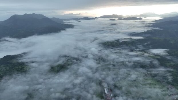 Aerial view of foggy mountain range and serene valley Spain.