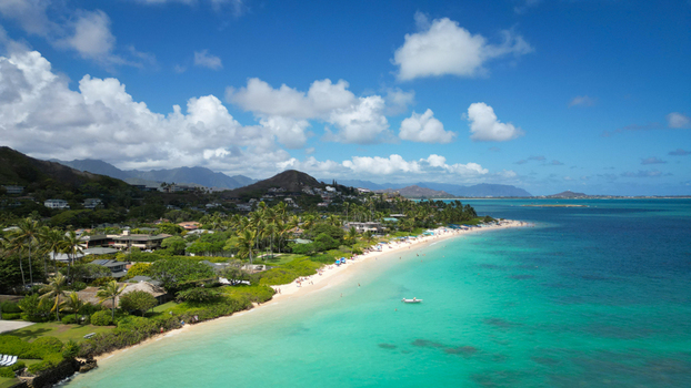 Aerial view of the serene Lanikai Beach with its powdery white sand meeting the turquoise ocean under a vast blue sky Kailua Hawaii United States. Aerial view of the serene Lanikai Beach with its powdery white sand meeting the turquoise ocean under a vast blue sky Kailua Hawaii United States.