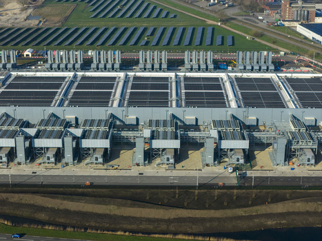 Aerial view of the Google data center featuring large industrial cooling units and solar panel arrays in Winschoten Groningen Netherlands.