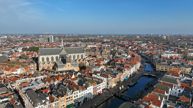 Aerial view of the historic city of Leiden featuring the Hooglandse Kerk traditional Dutch canal houses with red tiled roofs and winding canals in Leiden South Holland Netherlands.