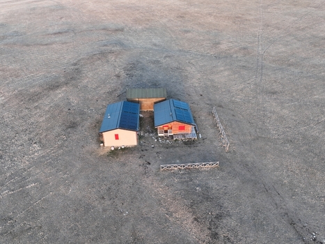 Aerial view of small mountain huts with solar panels on their roofs set in the vast open landscape of the Sibillini Mountains in Montemonaco Marche Italy.