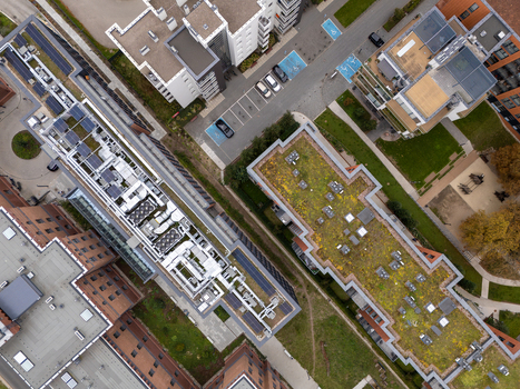 Aerial view of modern apartment buildings featuring green roofs solar panels and parking areas in Gdansk Poland. Aerial view of modern apartment buildings featuring green roofs solar panels and parking areas in Gdansk Poland.