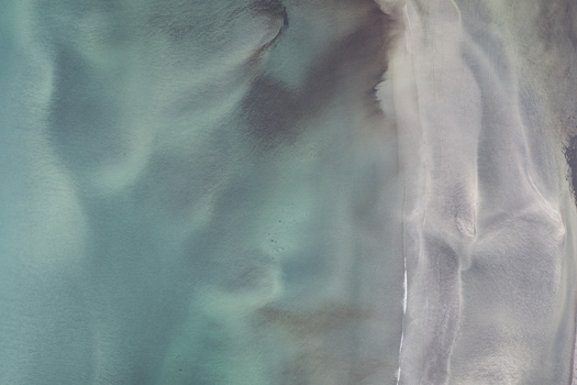 Aerial view of the turquoise waters and sandy coastline of Senja Troms Norway.