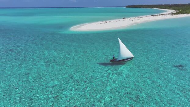 Aerial view of a traditional dhoni boat near a sandbank Maldives. Aerial view of a traditional dhoni boat near a sandbank Maldives.