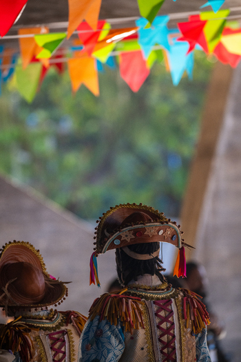 Rio de Janeiro Brazil 20 June 2026 View of people in traditional Festa Junina costumes with colorful flags hanging above. Rio de Janeiro Brazil 20 June 2026 View of people in traditional Festa Junina costumes with colorful flags hanging above.