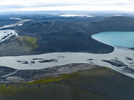 Aerial view of Skyggnisvatn lake surrounded by dark volcanic lava fields and braided glacial rivers in Hella Rangarthing ytra Iceland. Aerial view of Skyggnisvatn lake surrounded by dark volcanic lava fields and braided glacial rivers in Hella Rangarthing ytra Iceland.
