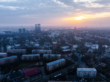 Aerial view of the Agenskalna priedes neighborhood at sunset featuring residential apartment blocks urban streets and the distant city skyline Riga Latvia. Aerial view of the Agenskalna priedes neighborhood at sunset featuring residential apartment blocks urban streets and the distant city skyline Riga Latvia.