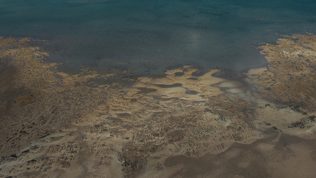 Aerial view of the intricate sand patterns and turquoise blue water along the coastline in Denham Western Australia Australia. Aerial view of the intricate sand patterns and turquoise blue water along the coastline in Denham Western Australia Australia.