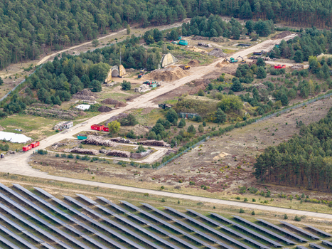Aerial view of the solar field at the former military airfield in Preschen featuring historic hangars runway and taxiway infrastructure in Neisse Malxetal Brandenburg Germany. Aerial view of the solar field at the former military airfield in Preschen featuring historic hangars runway and taxiway infrastructure in Neisse Malxetal Brandenburg Germany.