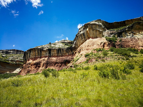 View of the dramatic sandstone cliffs and grassy slopes of Golden Gate Highlands National Park in Clarens Free State South Africa. View of the dramatic sandstone cliffs and grassy slopes of Golden Gate Highlands National Park in Clarens Free State South Africa.