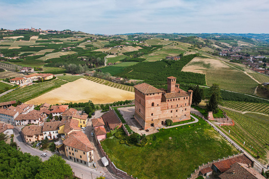 Aerial view of the medieval Grinzane Cavour Castle surrounded by lush vineyards and rolling hills in the Langhe region Grinzane Cavour Piedmont Italy. Aerial view of the medieval Grinzane Cavour Castle surrounded by lush vineyards and rolling hills in the Langhe region Grinzane Cavour Piedmont Italy.