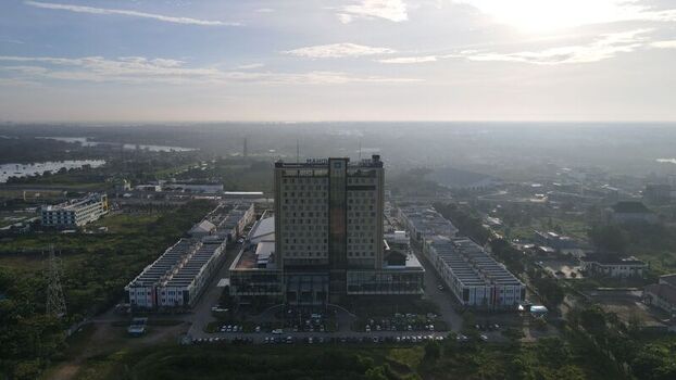 Aerial view of Jakabaring hotel complex surrounded by low rise buildings and green spaces in Kecamatan Seberang Ulu I Sumatera Selatan Indonesia. Aerial view of Jakabaring hotel complex surrounded by low rise buildings and green spaces in Kecamatan Seberang Ulu I Sumatera Selatan Indonesia.