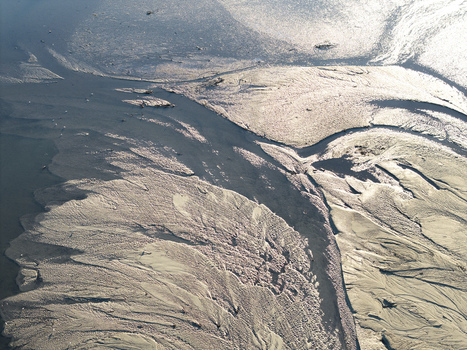 Aerial view of intricate sand textures and water channels in a river delta in Poland. Aerial view of intricate sand textures and water channels in a river delta in Poland.