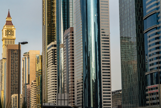 View of modern skyscrapers and the Al Yaqoub Tower along Sheikh Zayed Road under a clear sky in Dubai Dubai United Arab Emirates. View of modern skyscrapers and the Al Yaqoub Tower along Sheikh Zayed Road under a clear sky in Dubai Dubai United Arab Emirates.