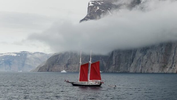 Aerial view of sailboat with red sails near Storoen Greenland. Aerial view of sailboat with red sails near Storoen Greenland.